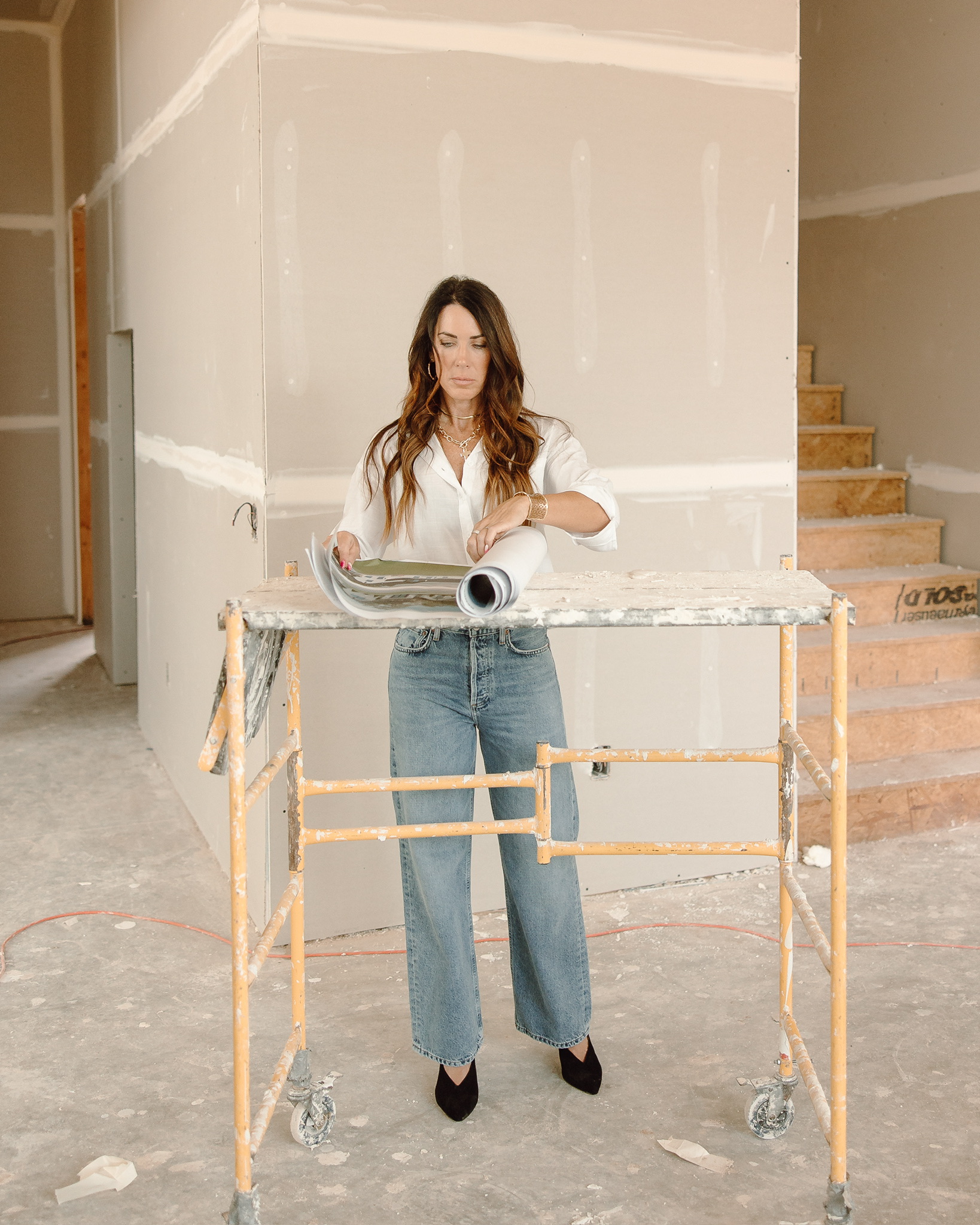 Julie reviewing blueprints at her job site